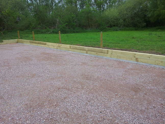 Car/Lorry park with drainage gulley and sleeper retaining wall 